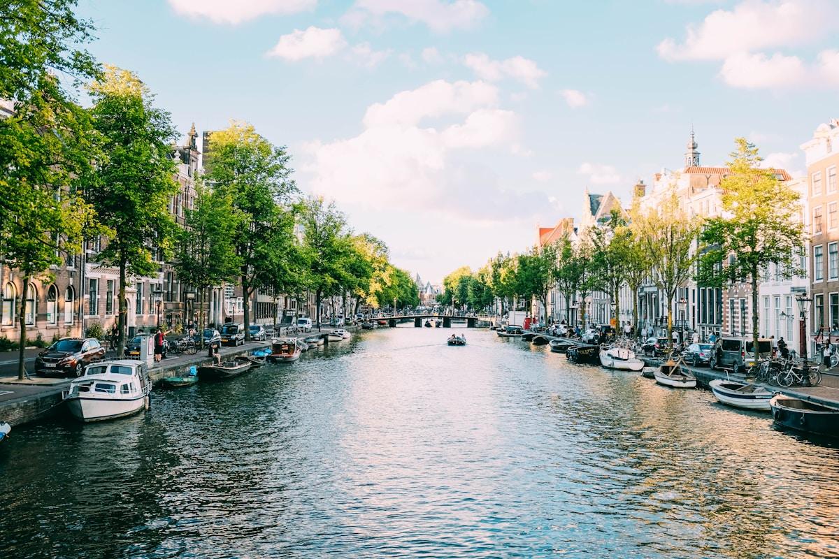 Traditional Dutch canal houses along an Amsterdam waterway representing student life in the Netherlands