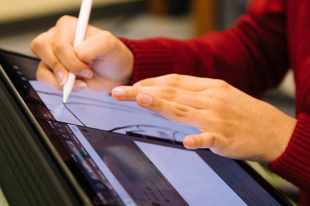 Student solving mathematical equations on paper during exam preparation