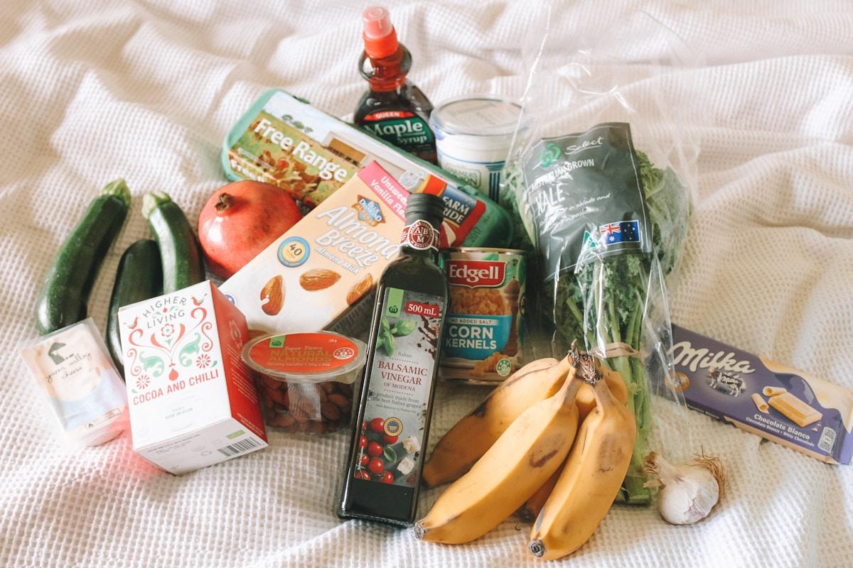 Fresh vegetables and groceries in a shopping basket representing food budgeting for Indian students abroad