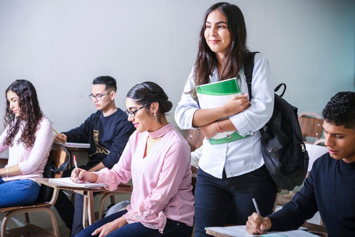 Student studying at a desk surrounded by medical textbooks